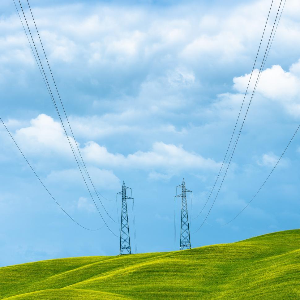 Free Image of Power lines on a green hill 