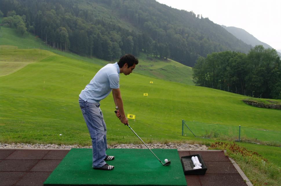 Free Image of Man Hitting Golf Ball With Golf Club 