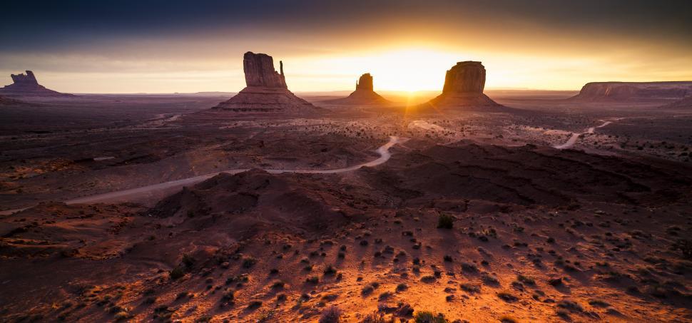 Free Image of A desert landscape with a sunset 