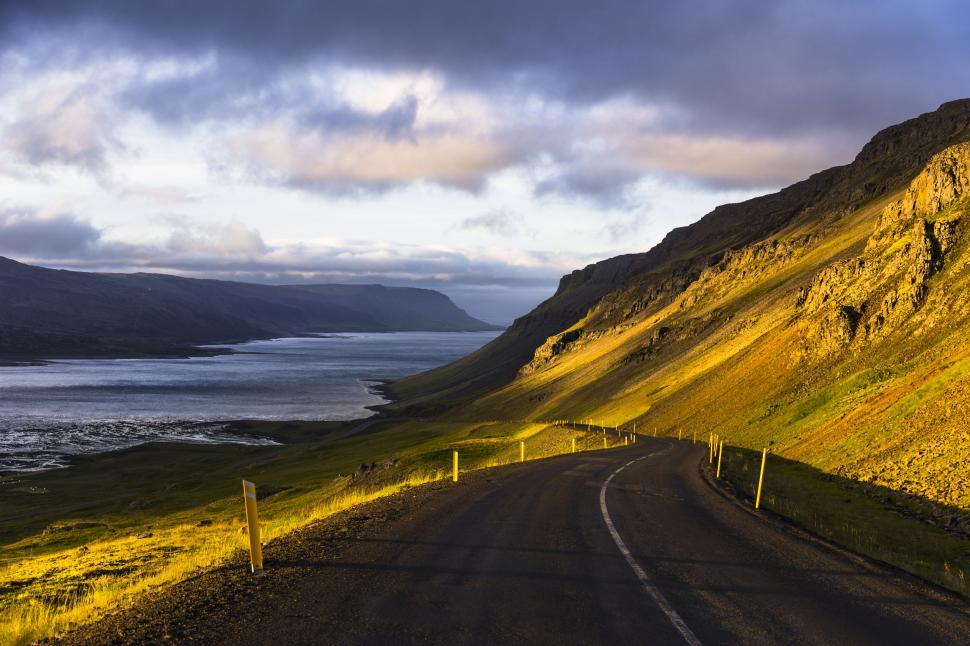 Free Image of A road leading to a body of water 