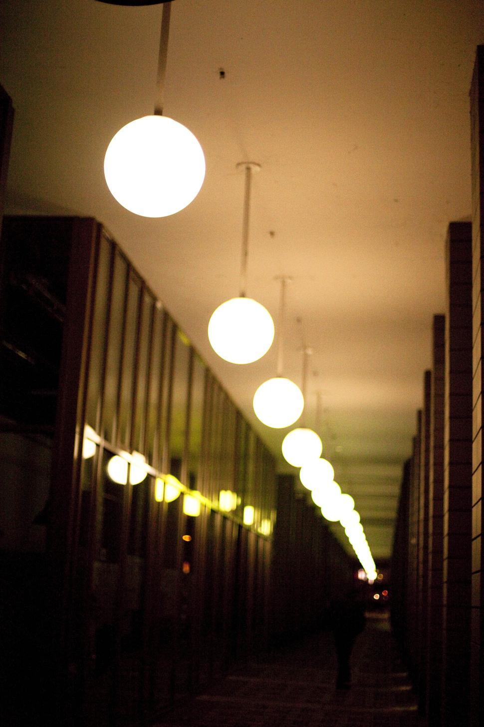 Free Image of A row of lights in a hallway 