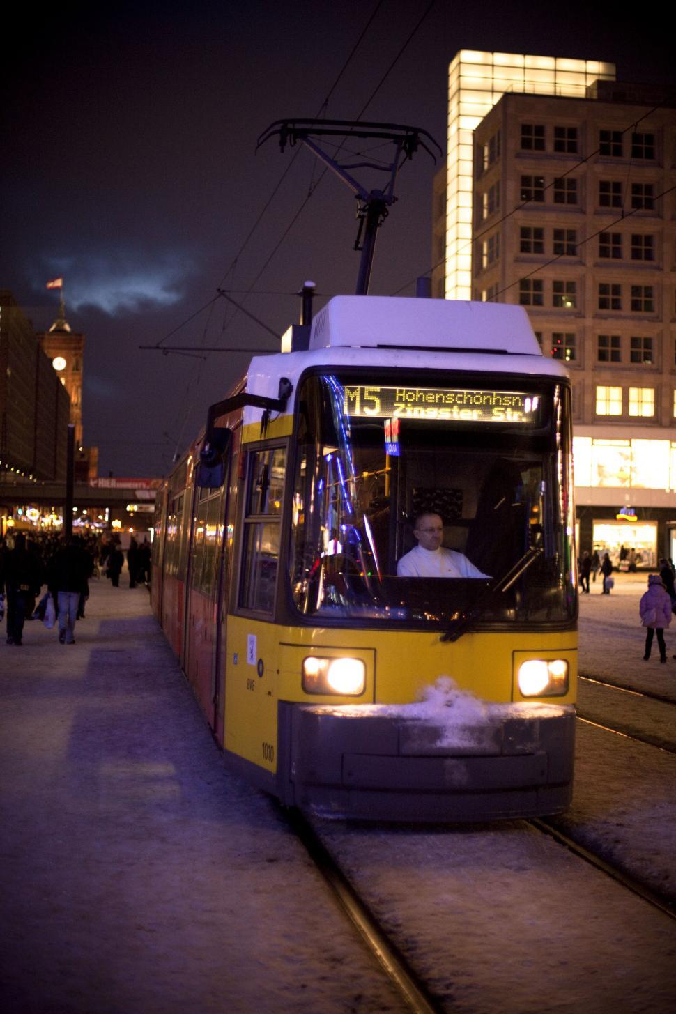 Free Image of A yellow and white train on a snowy street, Berlin, Germany 