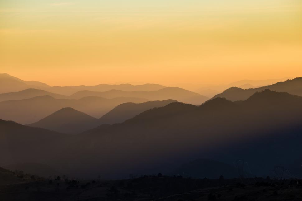Free Image of A silhouette of mountains with a sunset 