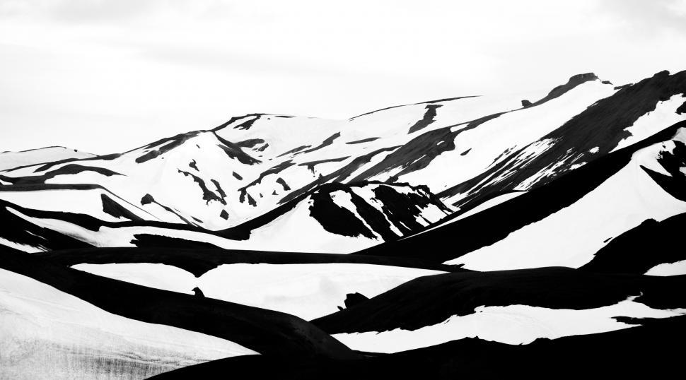 Free Image of A black and white photo of a snowy mountain 