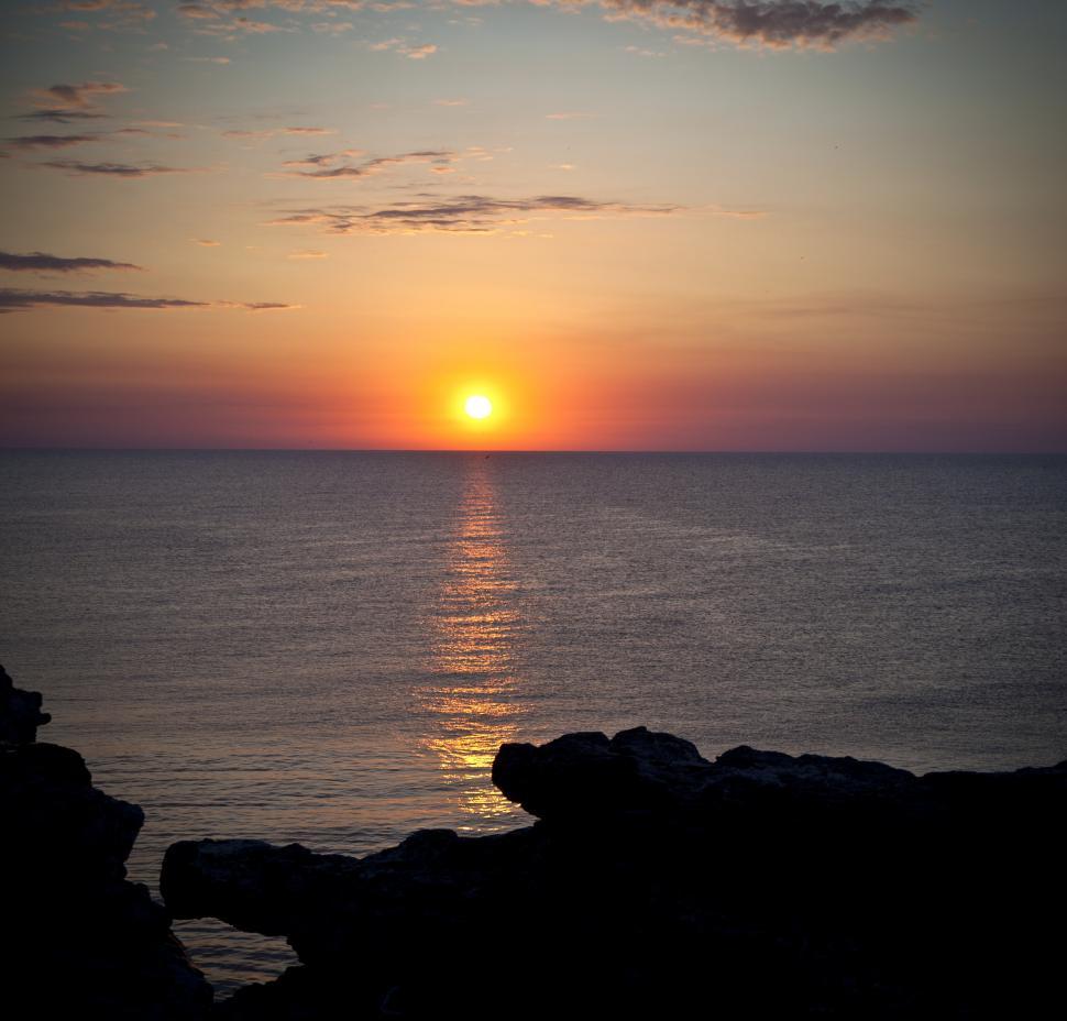 Free Image of A sunset over the ocean 
