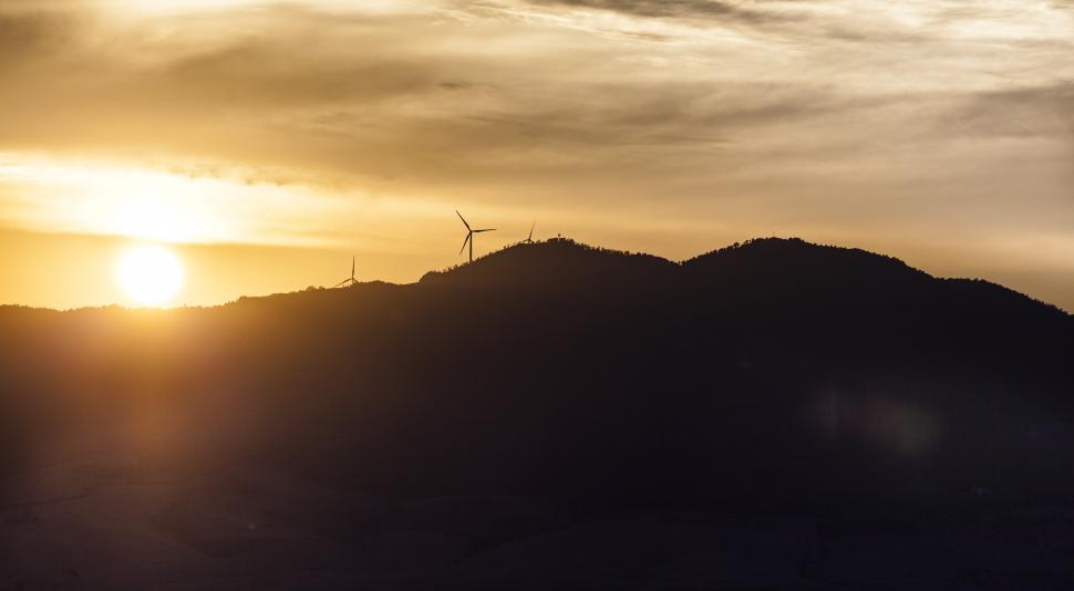 Free Image of A wind turbines on a hill 