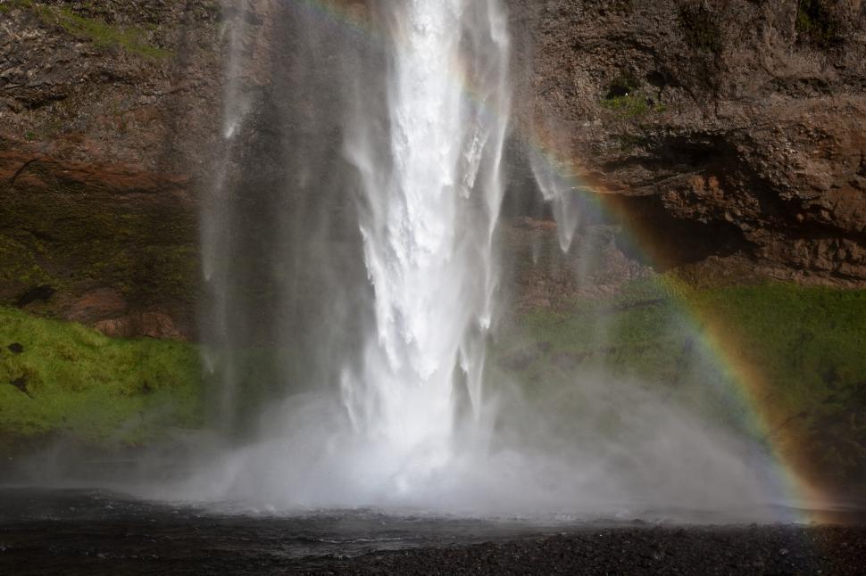 Free Image of A waterfall with a rainbow 