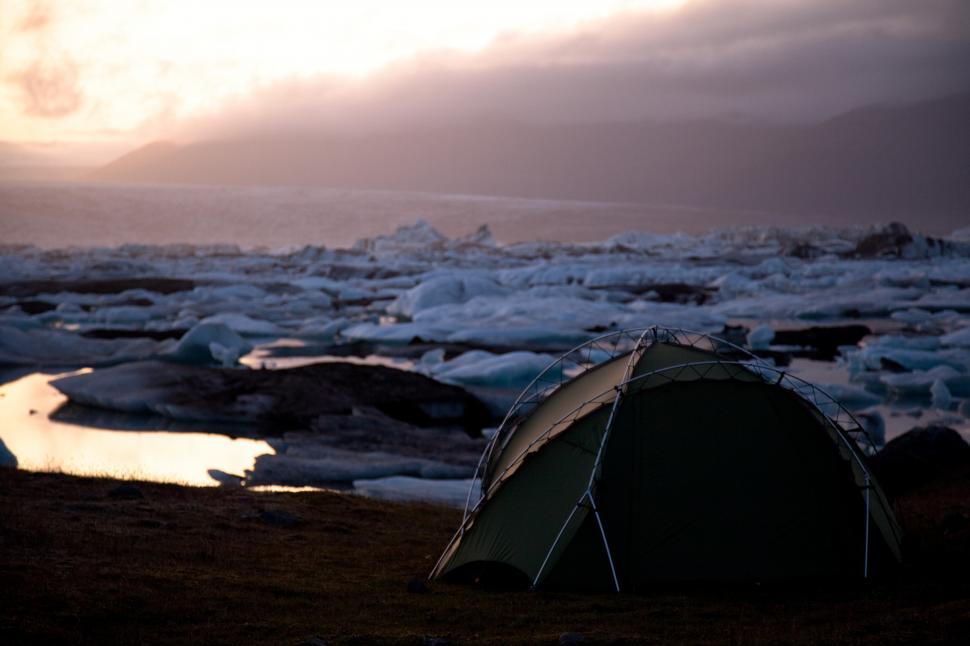 Free Image of A tent on the shore of a frozen lake 