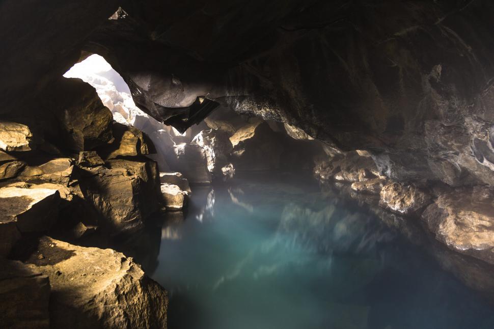 Free Image of A cave with a body of water 