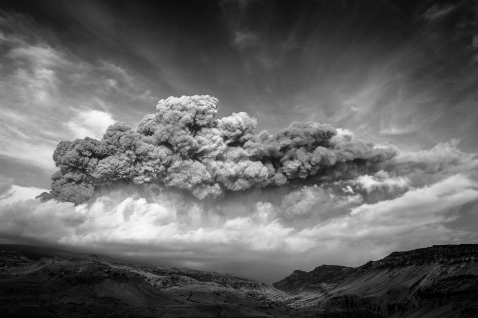 Free Image of A smoke billowing from a mountain 