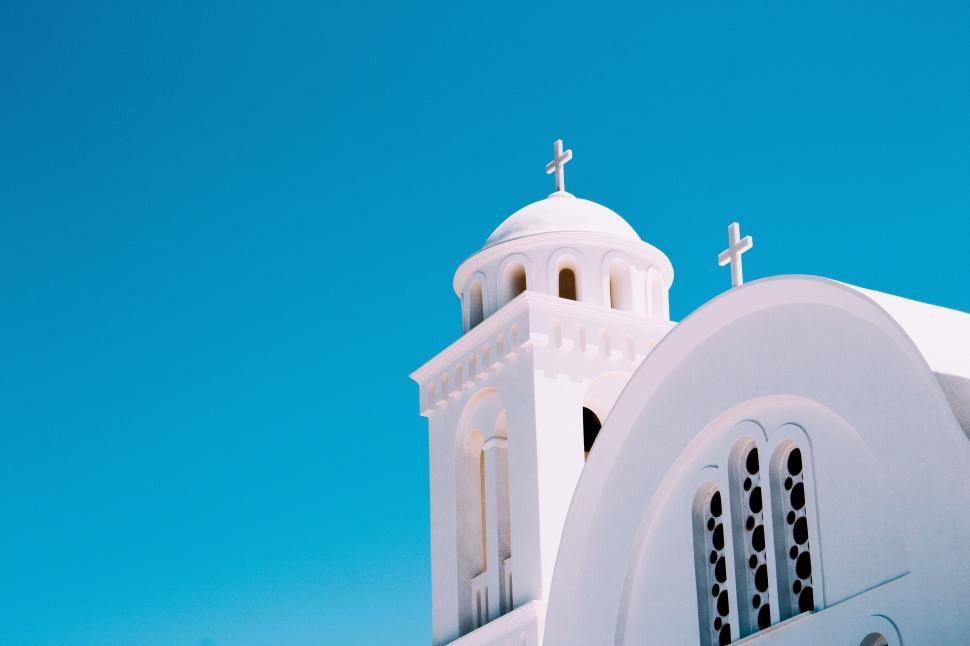 Free Image of A white church with crosses on top 