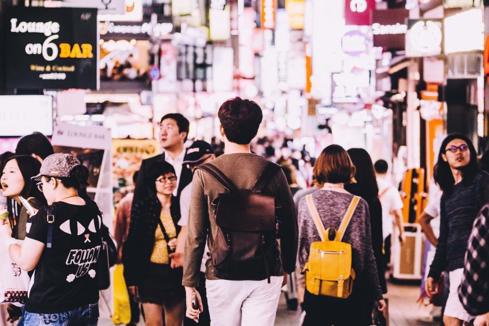 Free Image of A group of people walking in a busy city 