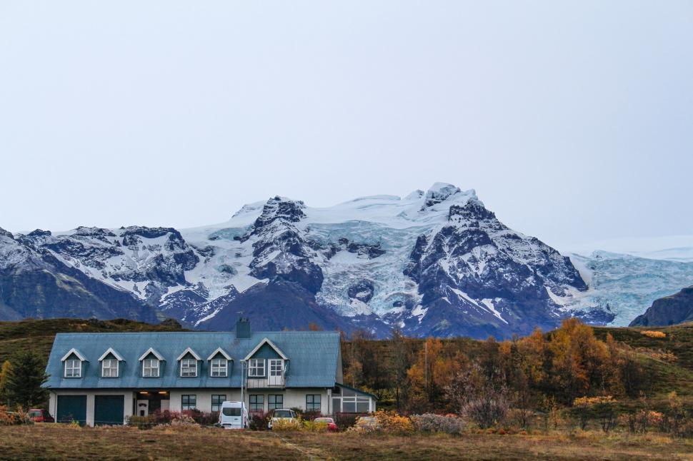 Free Image of A house with a snowy mountain in the background 