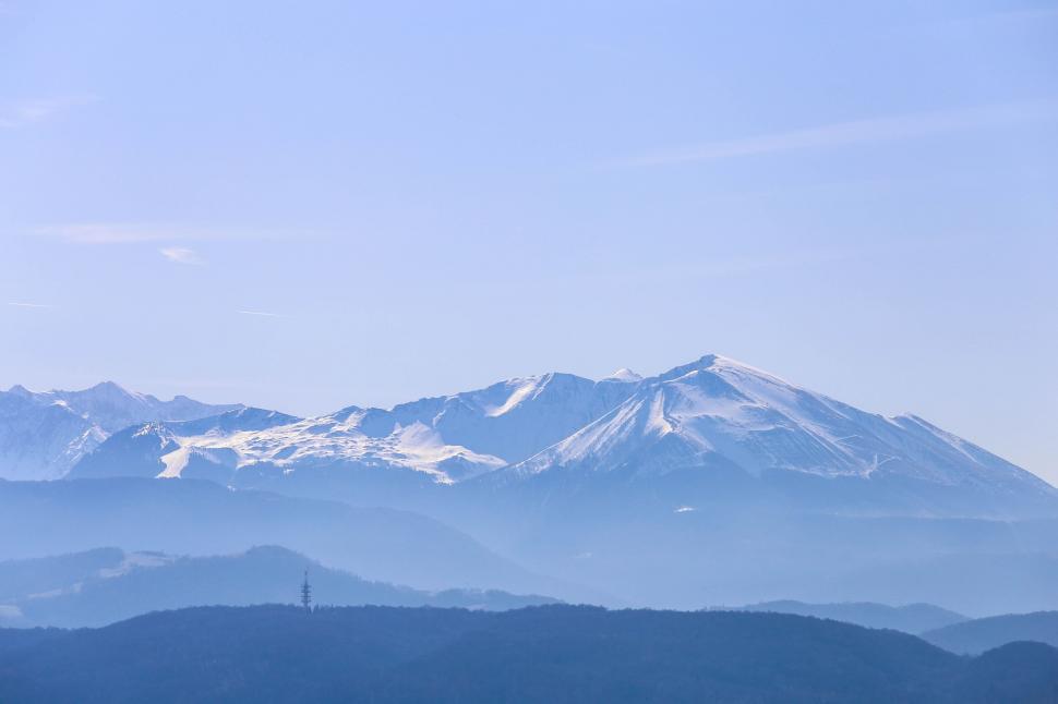 Free Image of A snowy mountain range with blue sky 