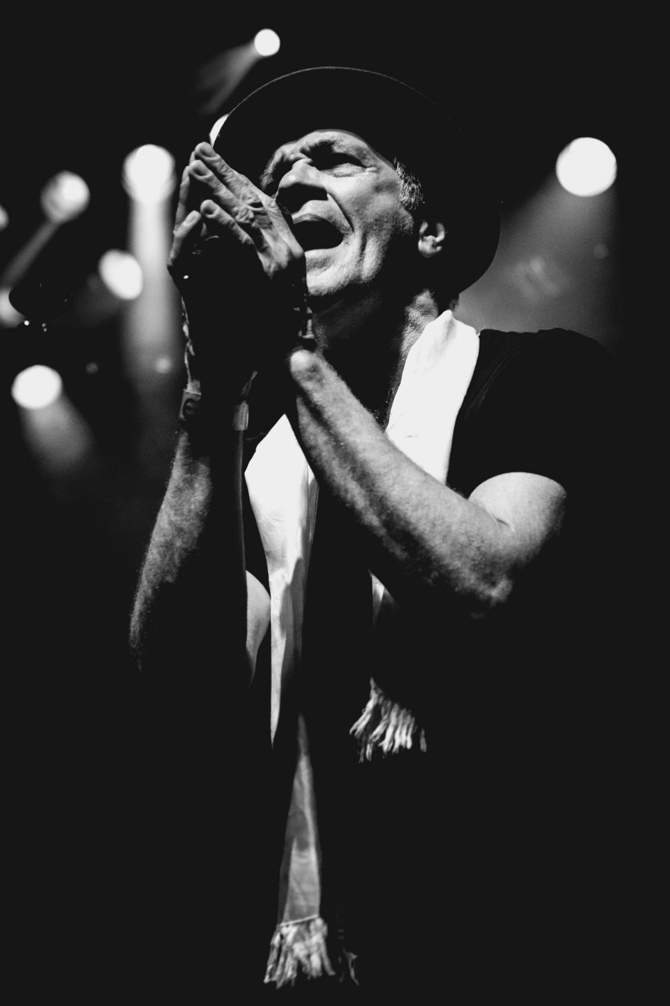 Free Image of A man singing into a microphone 