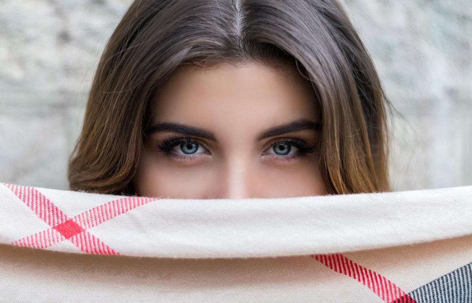 Free Image of A woman covering her face with a blanket 