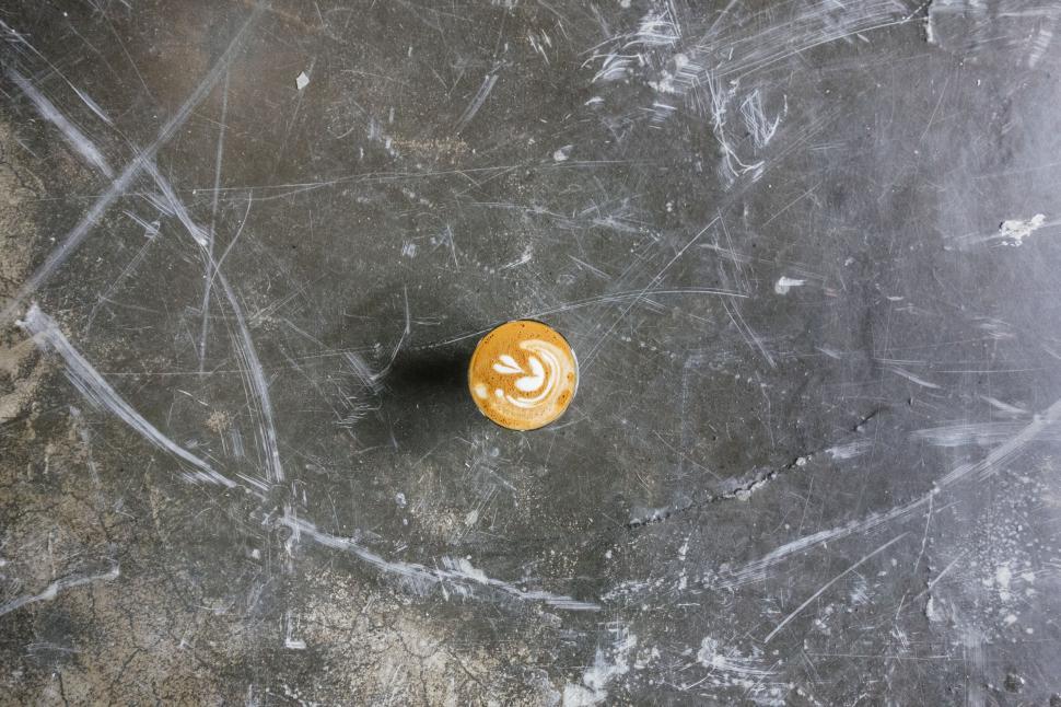 Free Image of A cup of coffee on a concrete surface 