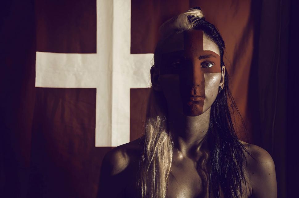 Free Image of A woman with a cross on her face 
