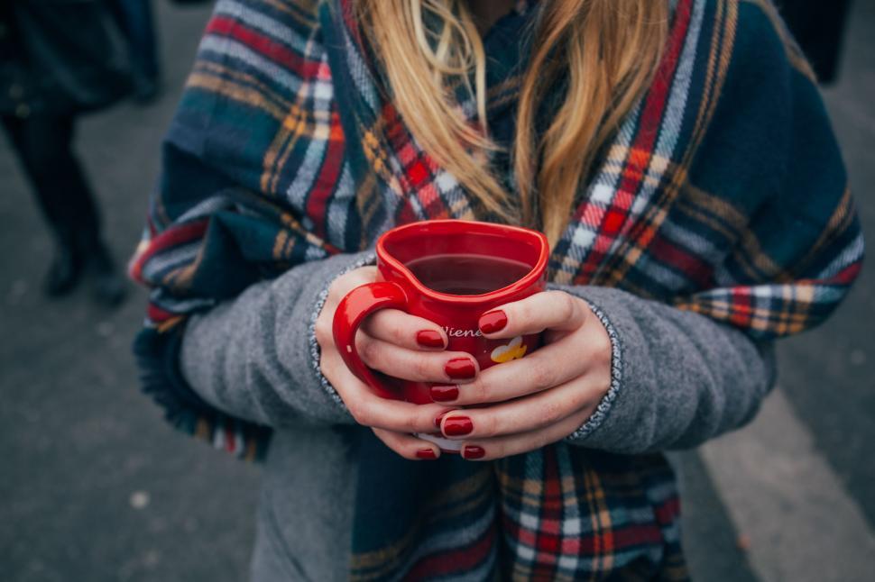 Free Image of A woman holding a red cup 
