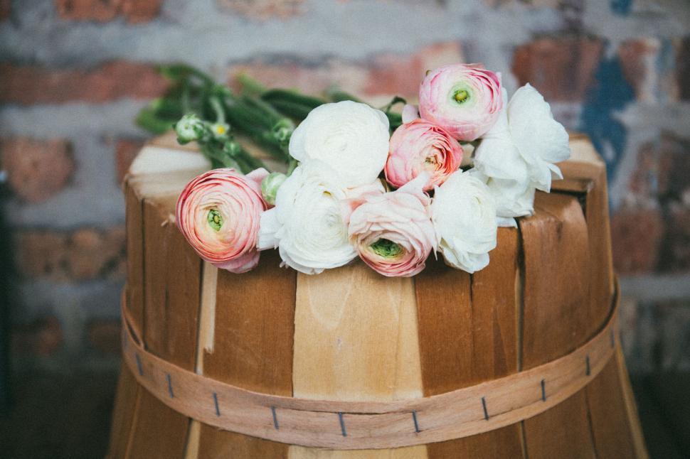 Free Image of A group of flowers on a barrel 