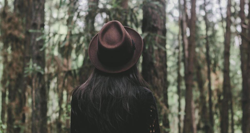 Free Image of A woman wearing a hat in the woods 