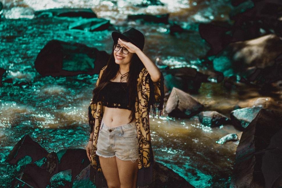 Free Image of A woman standing in front of a stream 