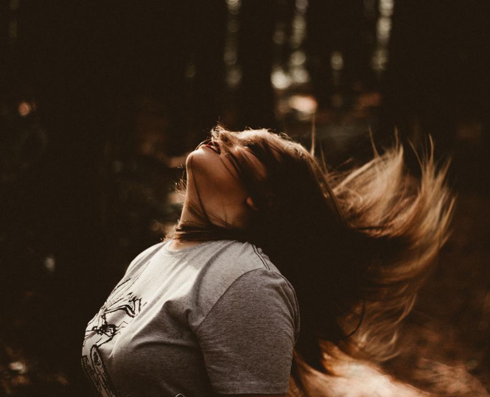 Free Image of A woman with her hair blowing in the wind 