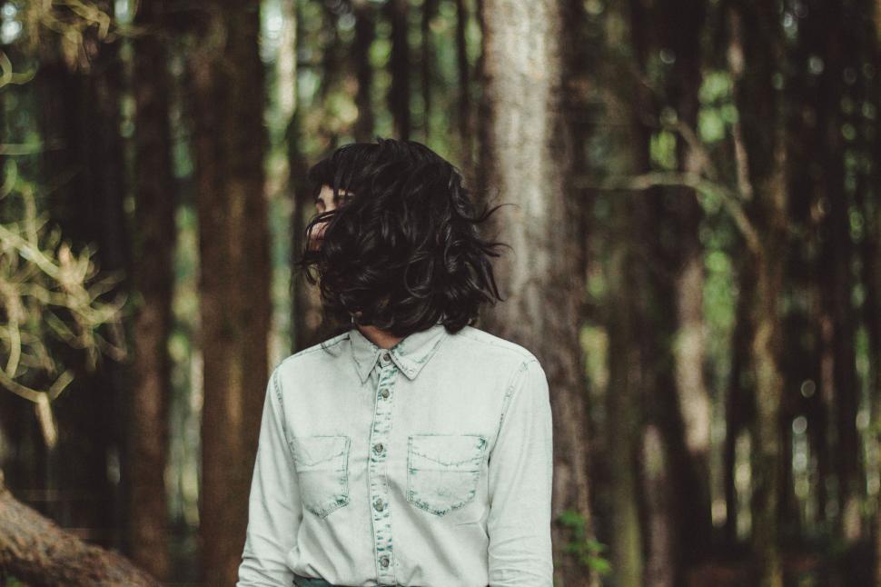 Free Image of A person with long hair in a forest 