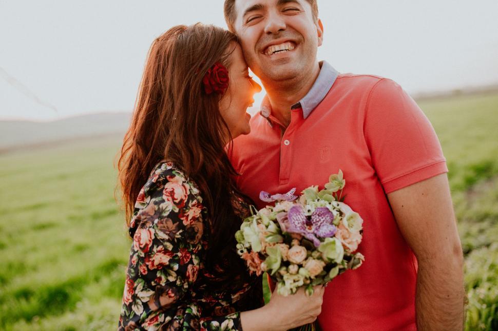 Free Image of A man and woman holding flowers 