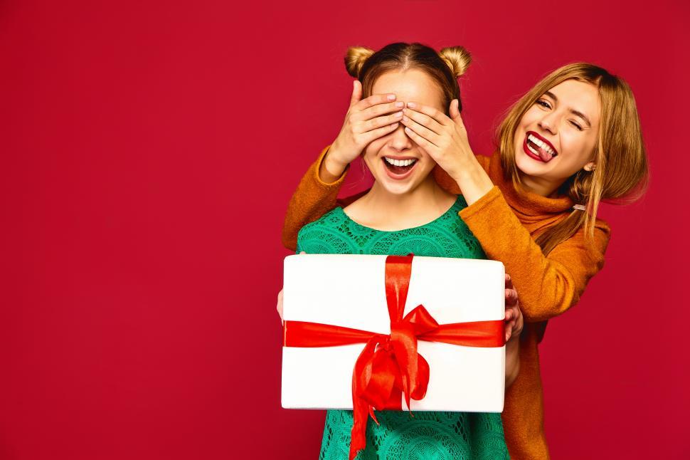Free Image of Two women holding a present 
