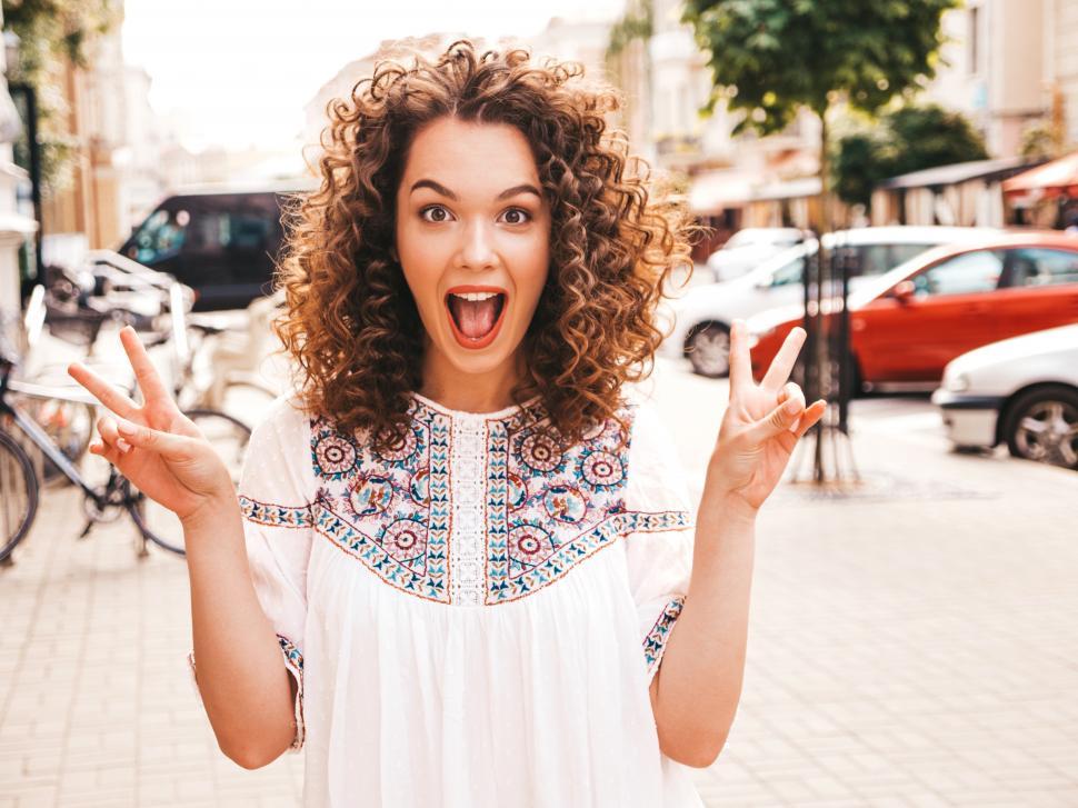 Free Image of A woman with curly hair and mouth open 