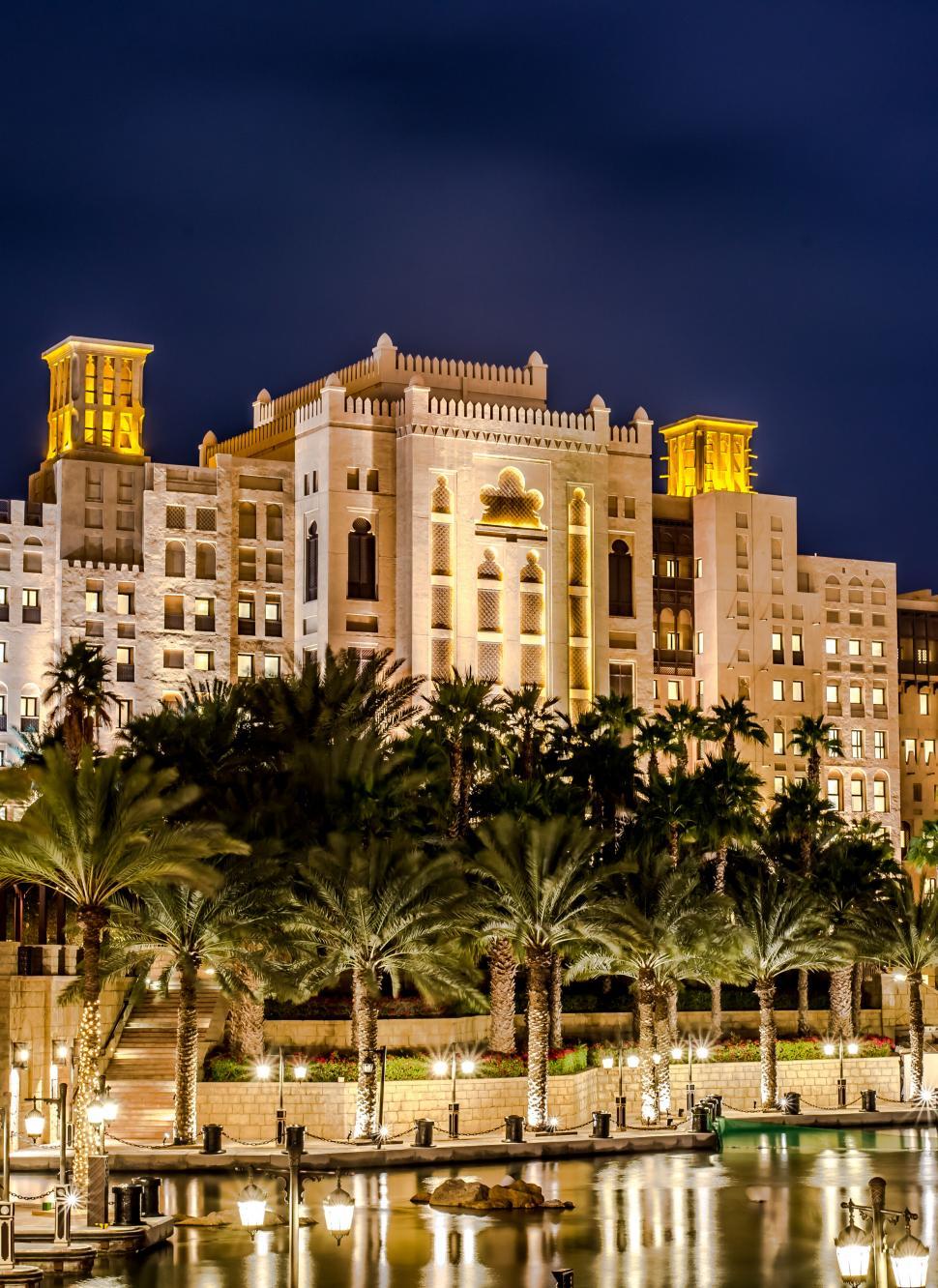 Free Image of A large building with palm trees 