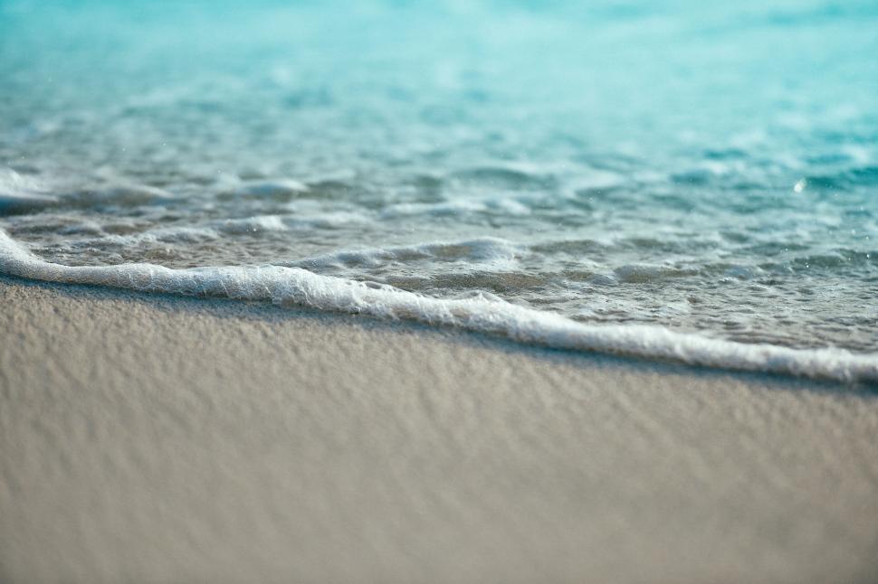 Free Image of A close-up of a wave on a beach 