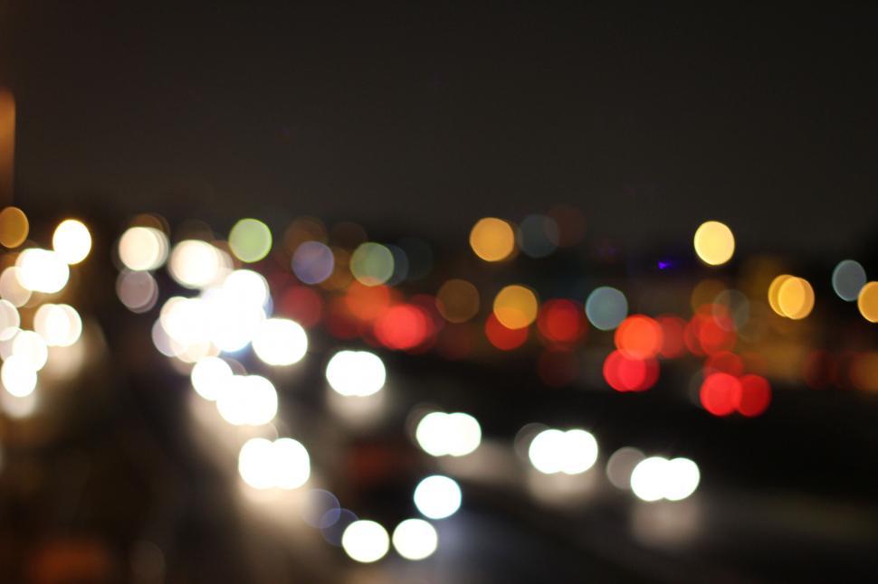 Free Image of A blurry image of a road with lights 