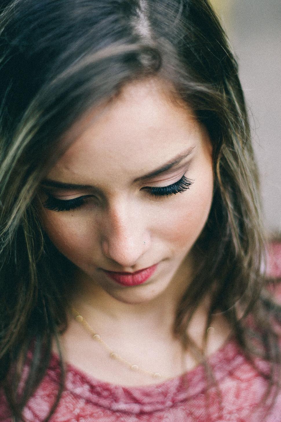 Free Image of A woman looking down with long eyelashes 