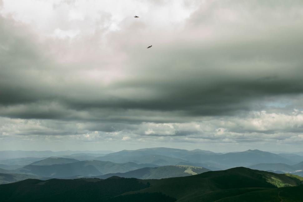 Free Image of A landscape with mountains and clouds 