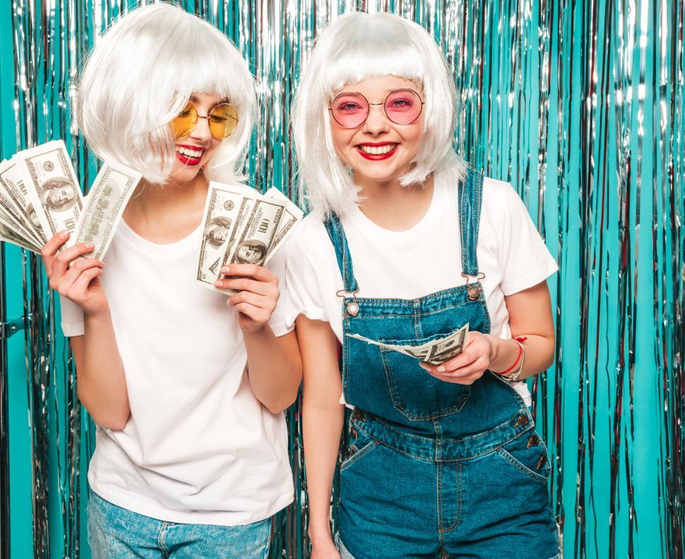 Free Image of Two women in white wigs holding money 