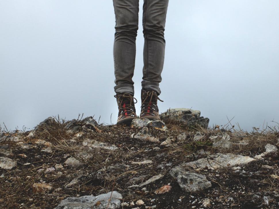 Free Image of A person standing on a rocky hill 