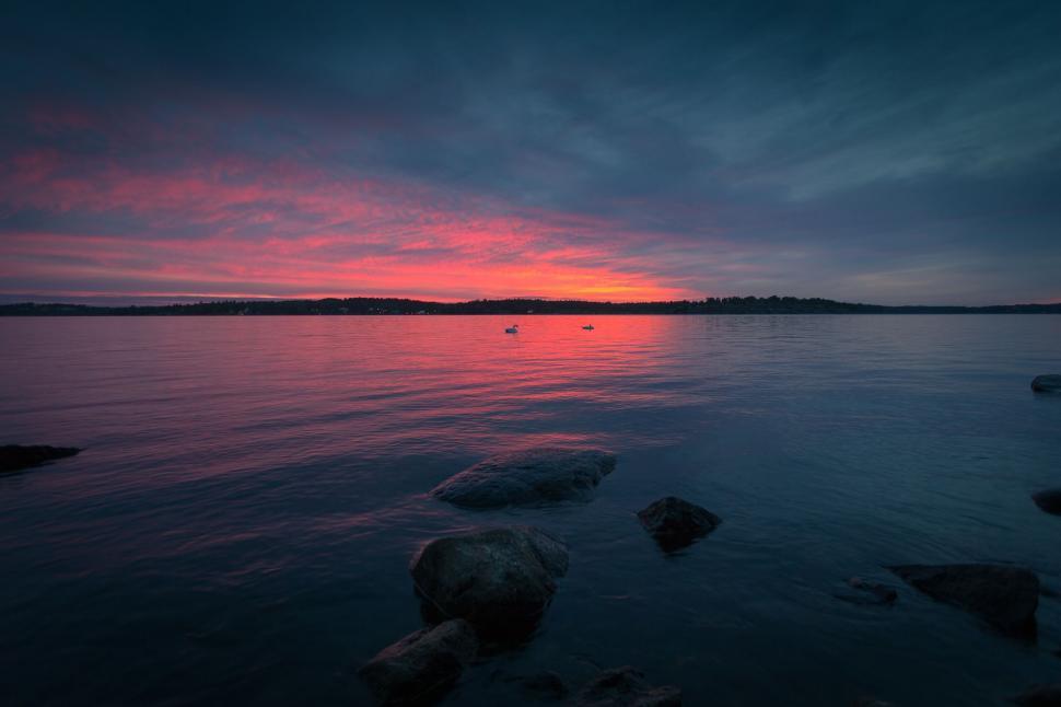 Free Image of A sunset over a body of water 