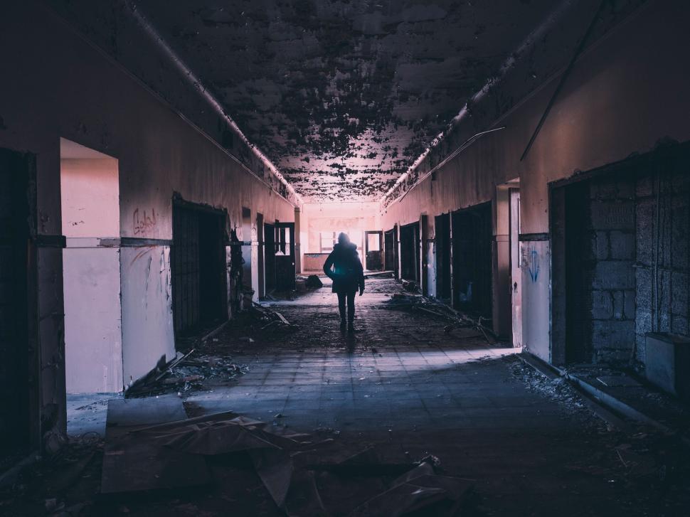 Free Image of A person walking in an abandoned building 