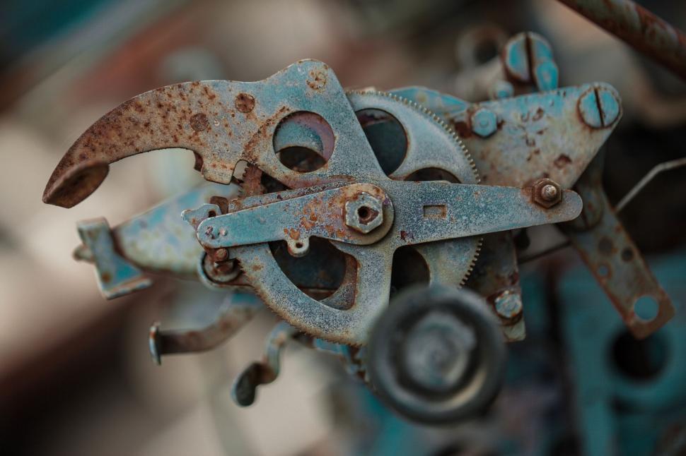 Free Image of A rusty metal mechanism with wheels 