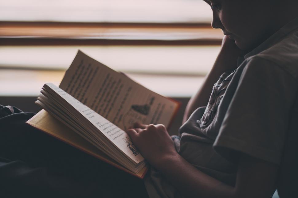 Free Image of A child reading a book 