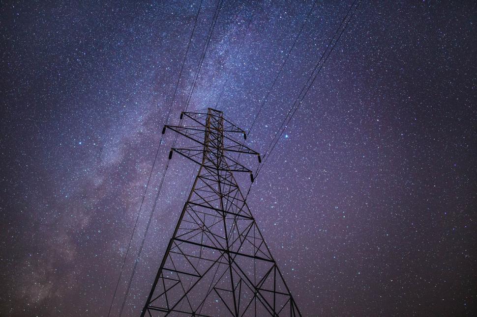 Free Image of A power line tower with stars in the sky 