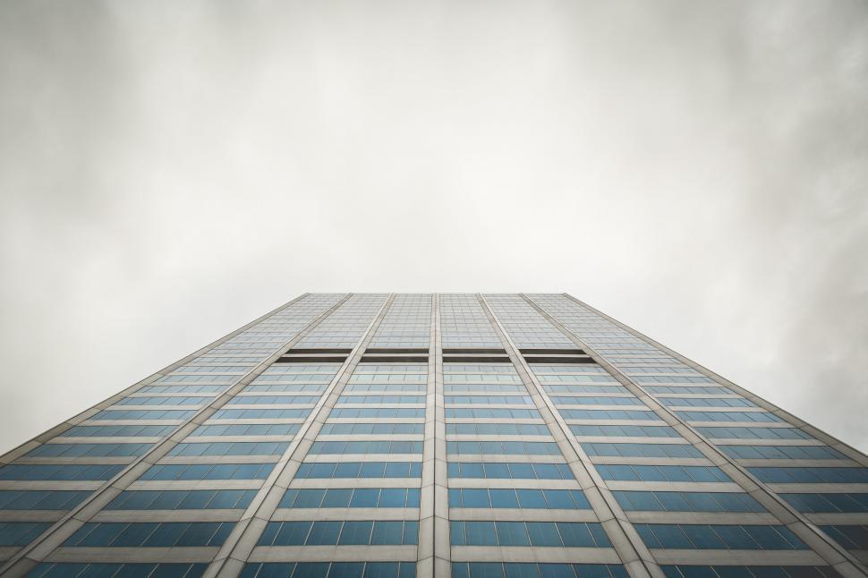 Free Image of Looking up a tall building with many windows 