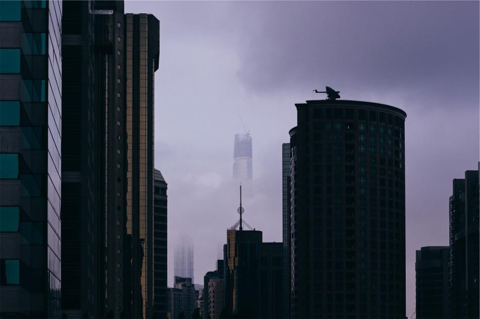 Free Image of A city with tall buildings and a tall tower 