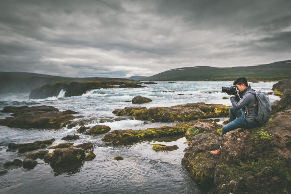Free Image of A person taking a picture of a river 