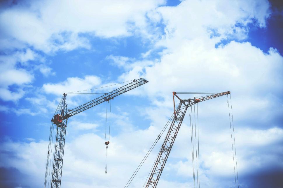 Free Image of A two cranes against a blue sky 