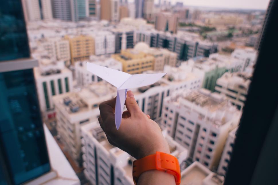 Free Image of A hand holding a paper airplane 