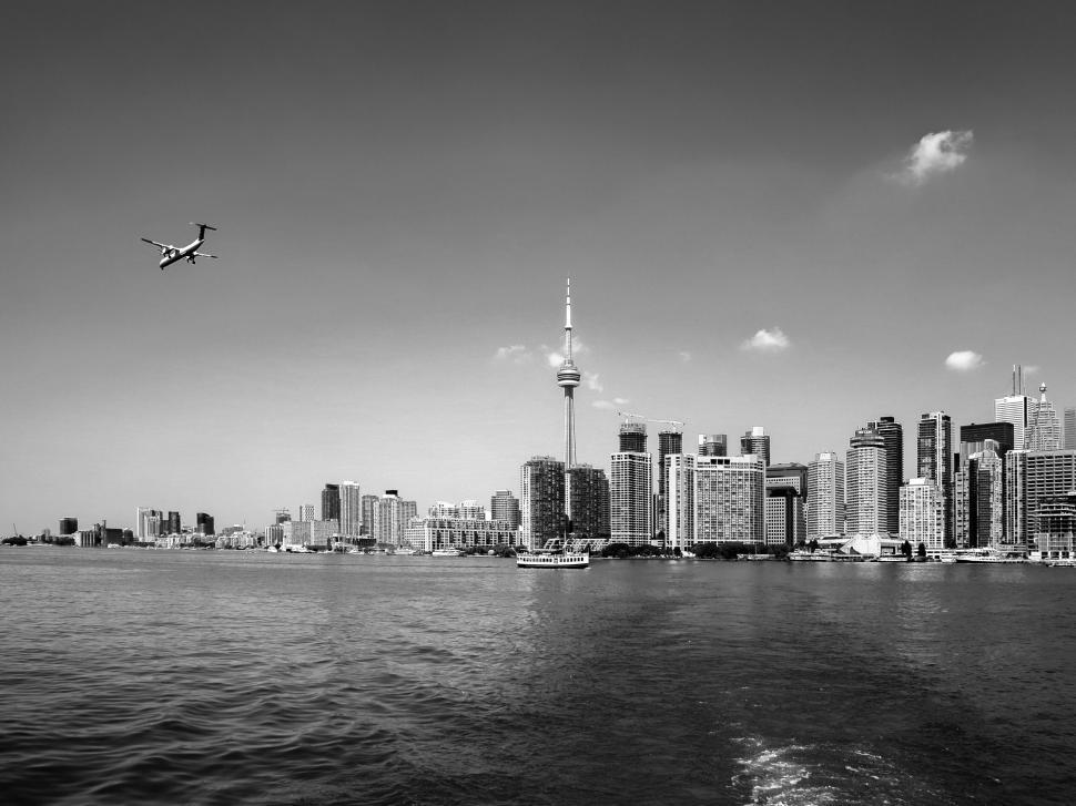 Free Image of A plane flying over a city 