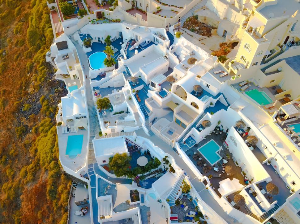 Free Image of A aerial view of a white building with a pool 